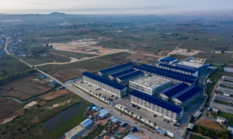 Drone footage of a scamming compound with high perimeter walls, security cameras, and security guards © Amnesty International 2025