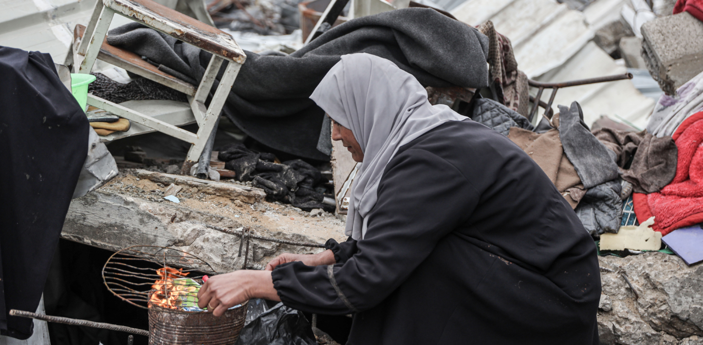GAZA CITY, GAZA - MARCH 07: Hind al-Nawajiha, a 40-year-old Palestinian mother of five who lost her husband in the Israeli attacks, prepares food for her children ahead of the International Women's Day in Gaza City, Gaza on March 07, 2025. Hind al-Nawajiha struggles to survive with her children in a makeshift tent they set up on the rubble of their home. (Photo by Abdul Hakim Abu Riash/Anadolu via Getty Images)