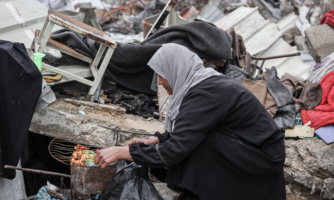 GAZA CITY, GAZA - MARCH 07: Hind al-Nawajiha, a 40-year-old Palestinian mother of five who lost her husband in the Israeli attacks, prepares food for her children ahead of the International Women's Day in Gaza City, Gaza on March 07, 2025. Hind al-Nawajiha struggles to survive with her children in a makeshift tent they set up on the rubble of their home. (Photo by Abdul Hakim Abu Riash/Anadolu via Getty Images)