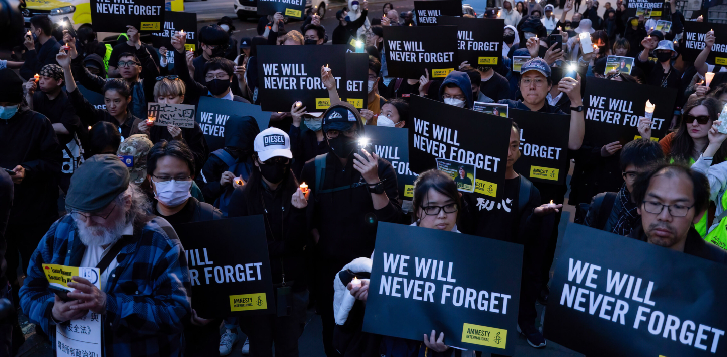 LONDON, UNITED KINGDOM - 2023/06/04: Participants are seen holding posters and candles during the vigil. A candle-lit vigil organised by the Amnesty International took place outside the Chinese Embassy in London as a tradition in memorial of the people who died in the 1989 Tiananmen Massacre. (Photo by Hesther Ng/SOPA Images/LightRocket via Getty Images)